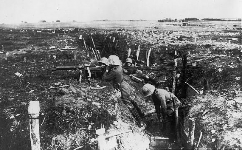 Soldiers shoot from trench
